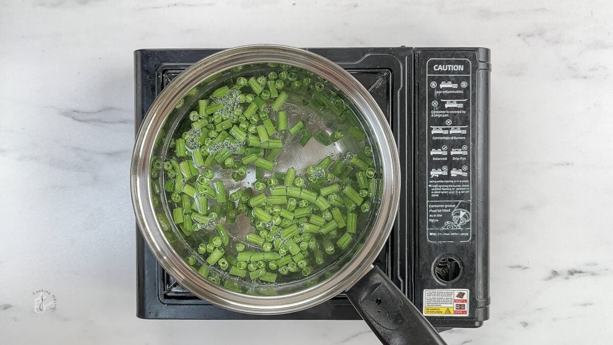 green beans blanching in the pan to add in zucchini ribbon salad prada cafe copycat