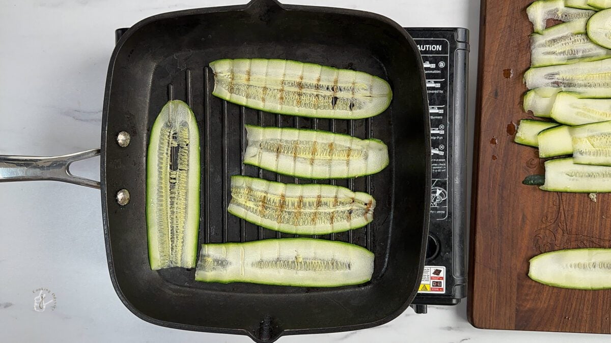 charred zucchini ribbons on a pan 