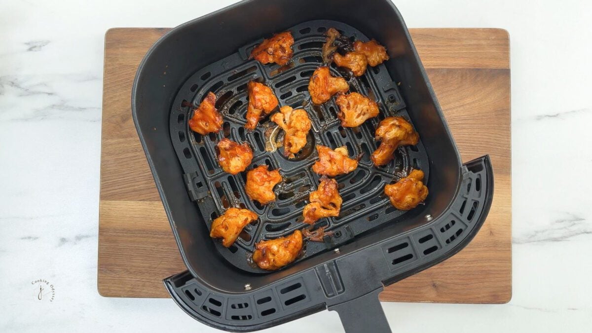 air fryer buffalo cauliflower bites in the air fryer basket