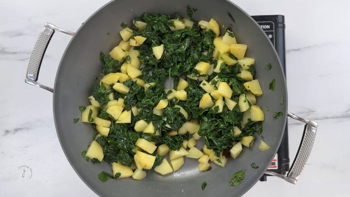 wilted methi and aloo in the pan 