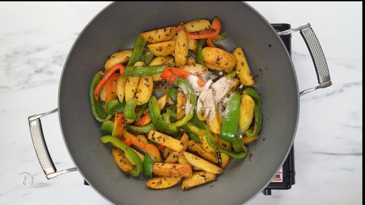 sugar and dry mango powder added to the aloo shimla mirch curry