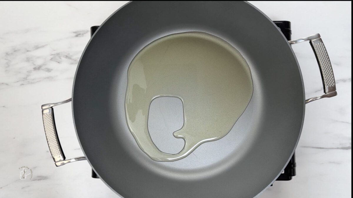 oil heating in a pan to make aloo shimla mirch ki sabzi