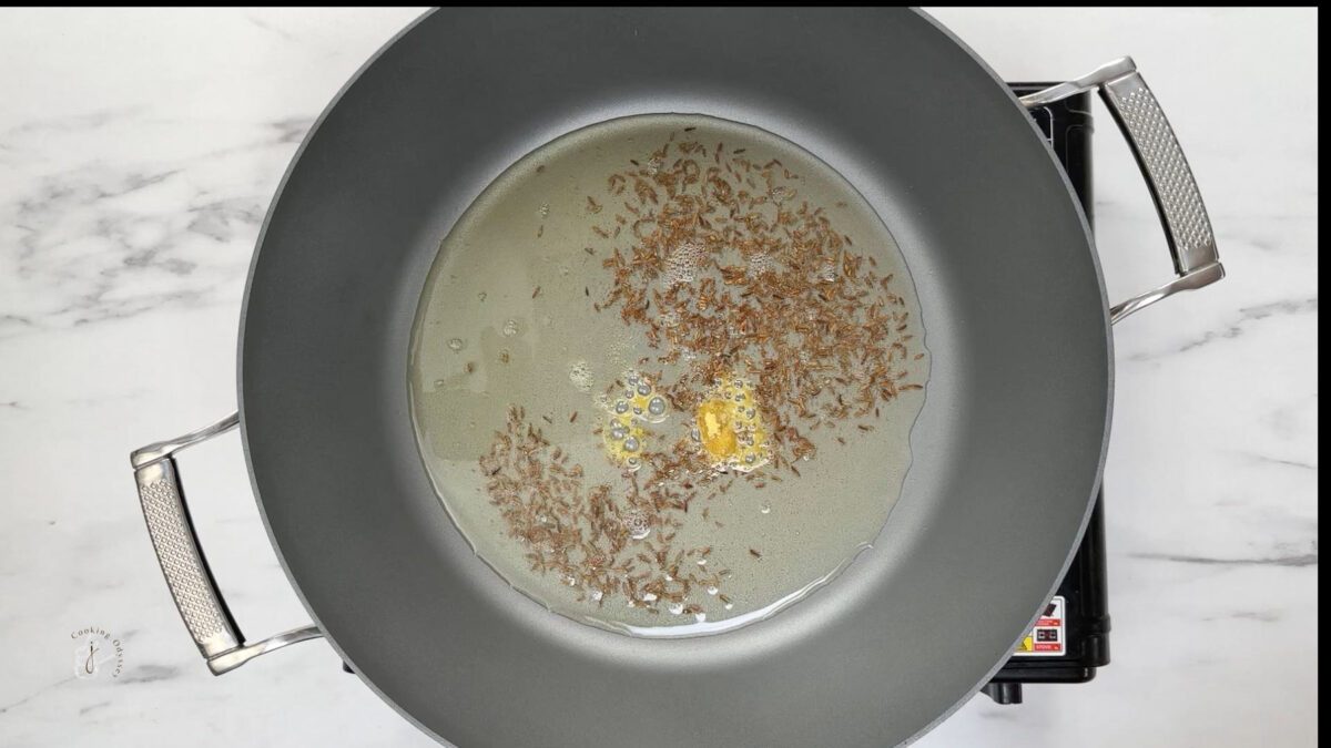 cumin seeds and hing sizzling in the hot oil