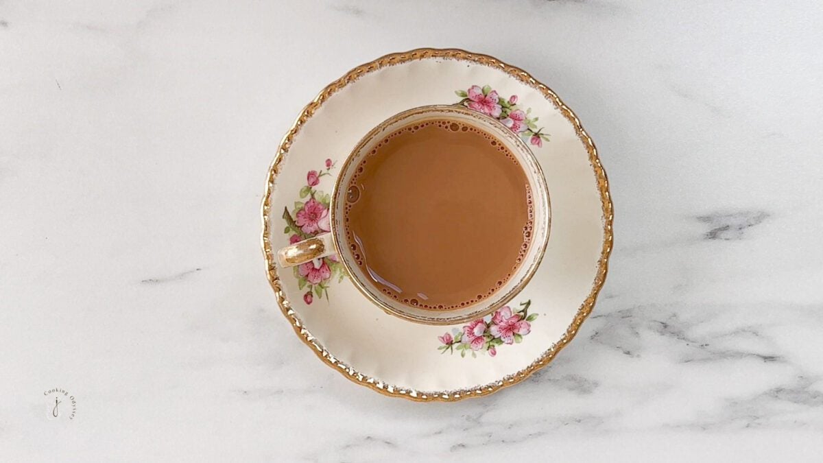 cardamom tea served in a tea cup and saucer