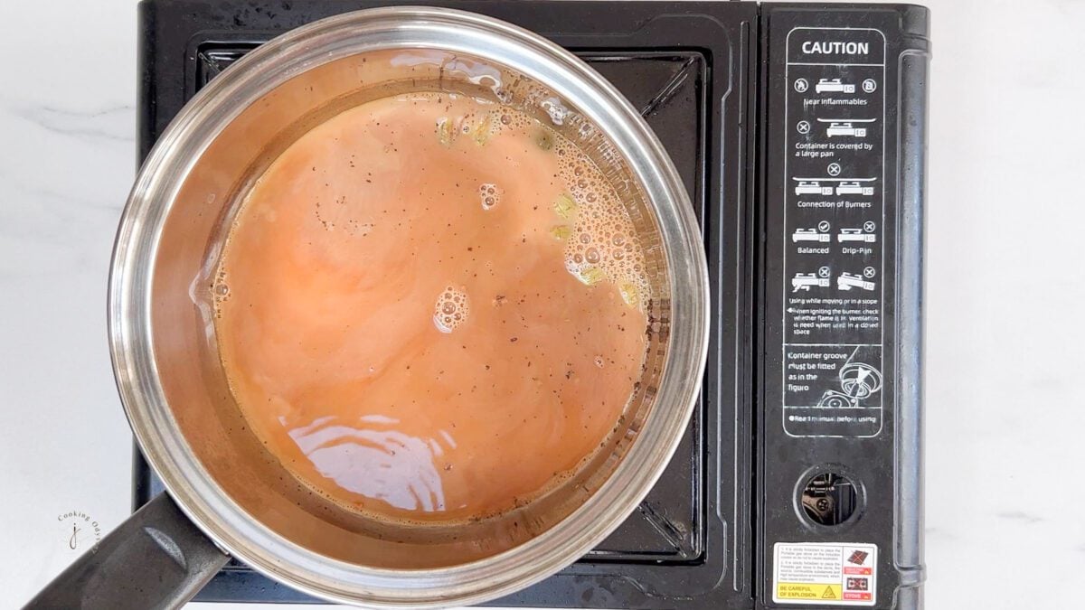 milk added to the boiling black tea water to make Indian cardamom tea