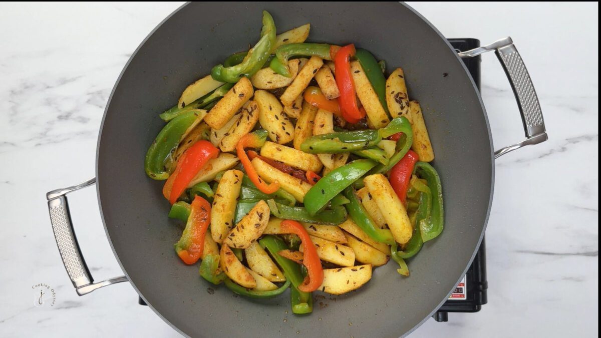 sauteed bell peppers and potatoes in the pan