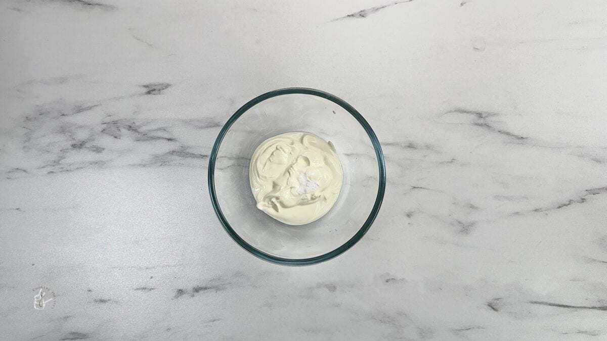 yogurt and baking soda in the bowl to make rasmalai cake without eggs