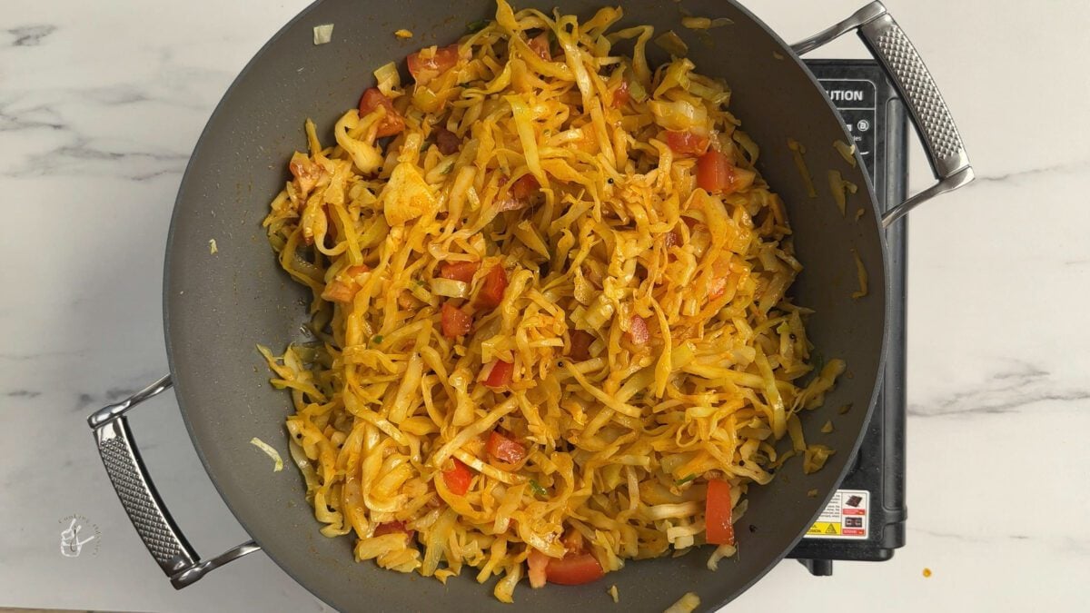 cabbage sabzi cooking in the frying pan on the stove
