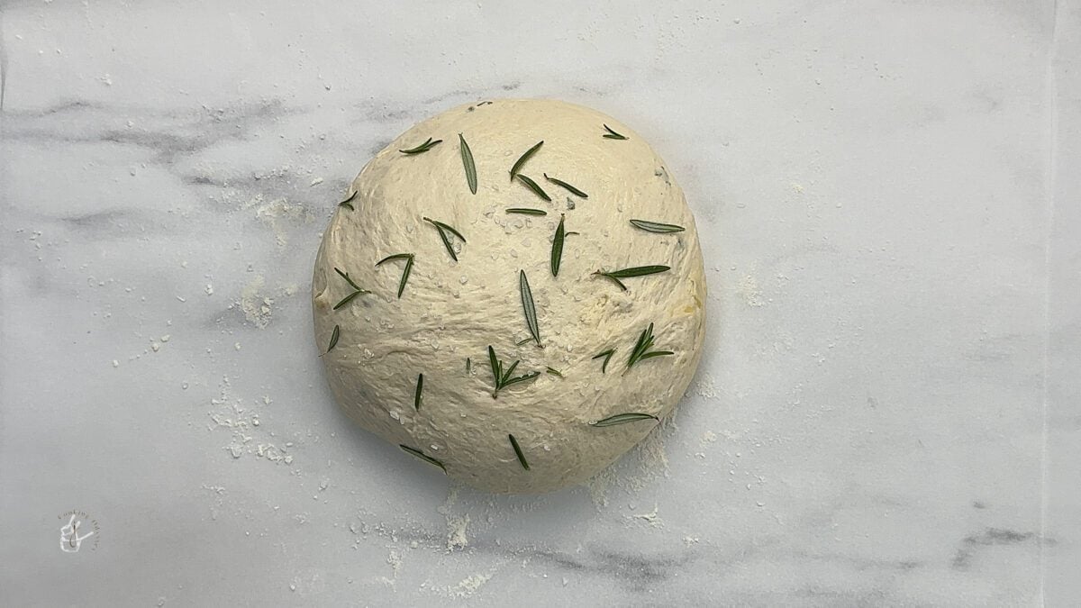 no knead bread dough ball on the parchment paper for second proving