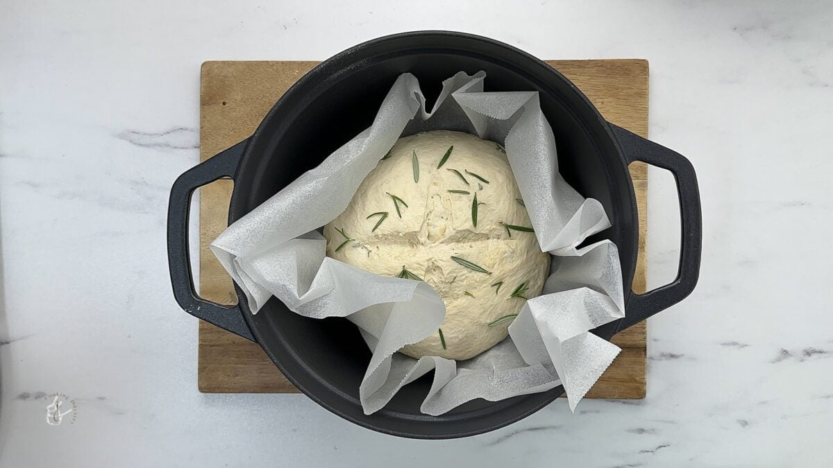 bread dough in the dutch oven on parchment paper