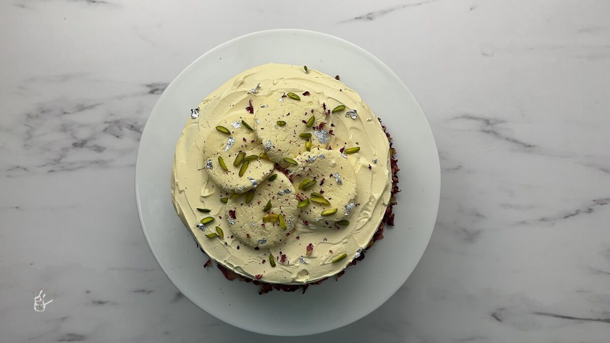 Rasmalai cake eggless decorated with nuts and rose petals