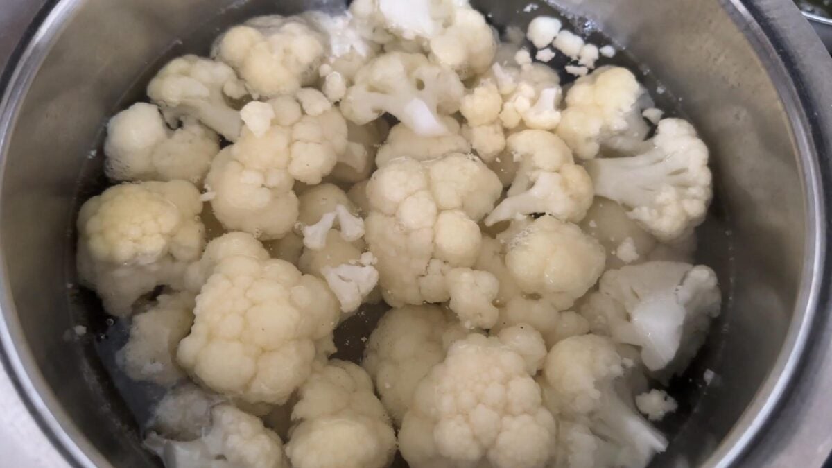 cauliflower florets blanching in boiling water in the large pot