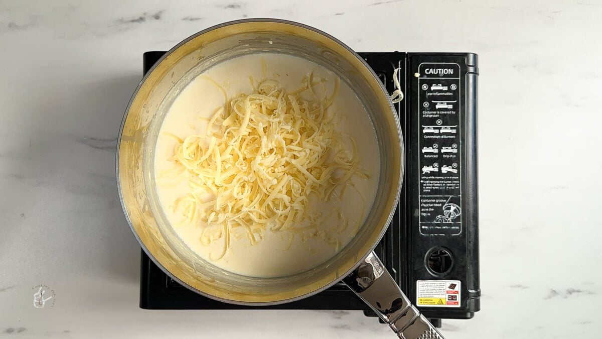 grated cheese added to the milk and flour mixture