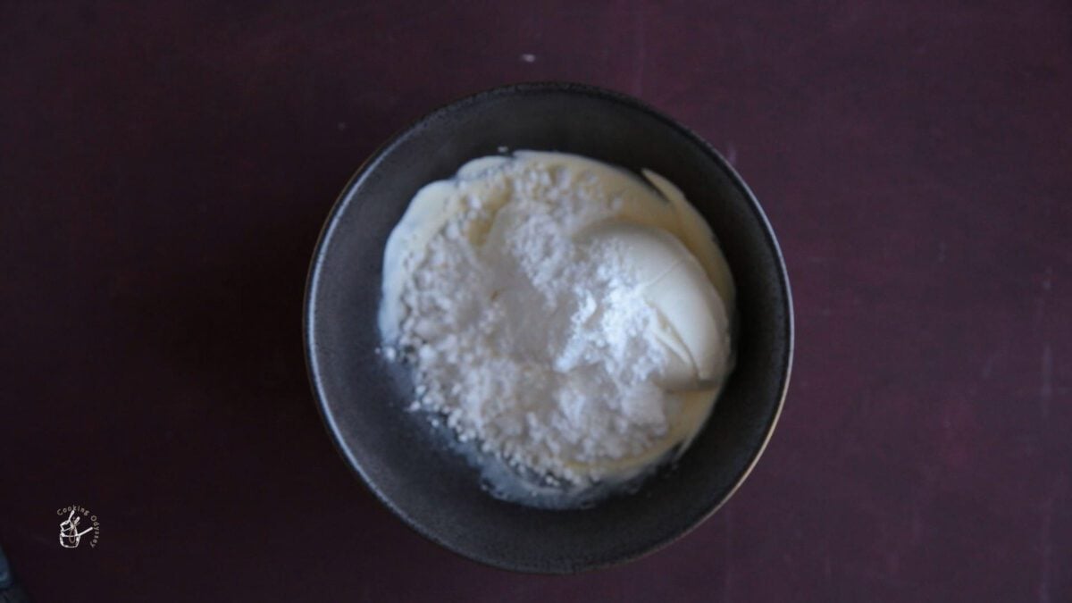 cheese added to the whipped cream in a bowl