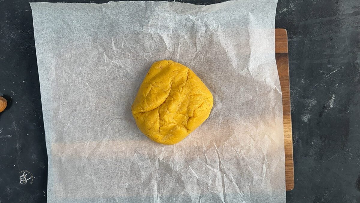 dough of badam katli placed on parchment paper