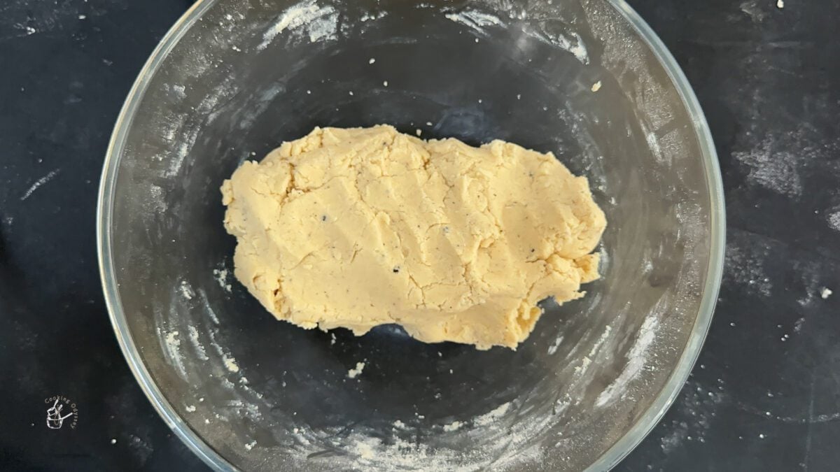 milk powder shortbread dough in a clear mixing bowl