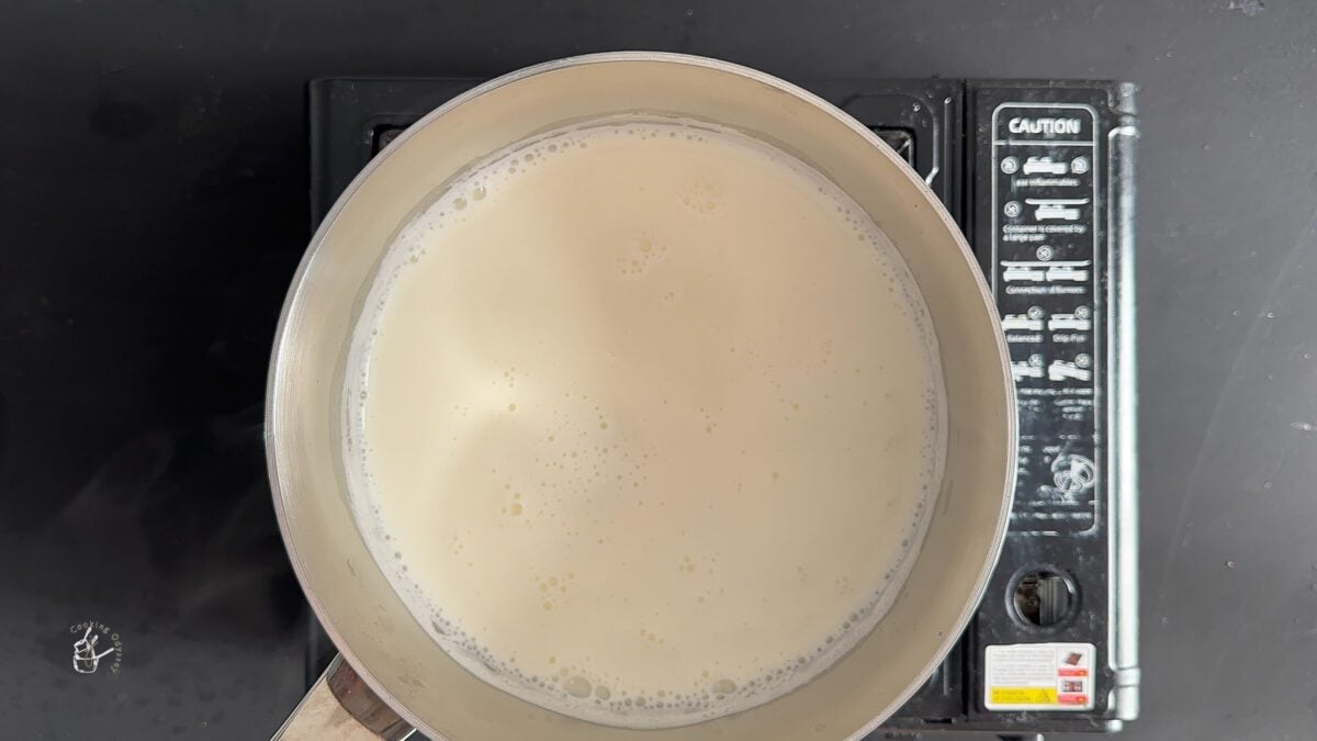 full-fat milk heating in a milkpan to make kesar milk.