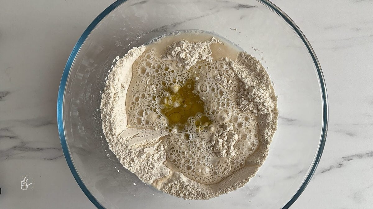 air fryer bread ingredients in a clear mixing bowl.