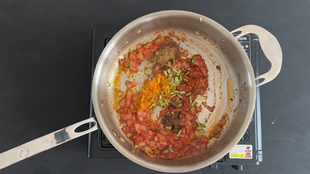 spices powders added the onion tomato curry base in the pan.