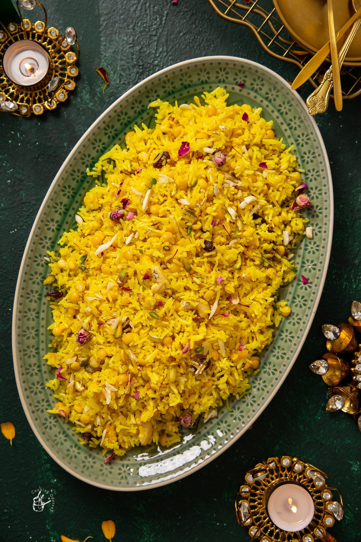 biranj gujrati sweet rice served in a oval green serving tray, placed on a table.