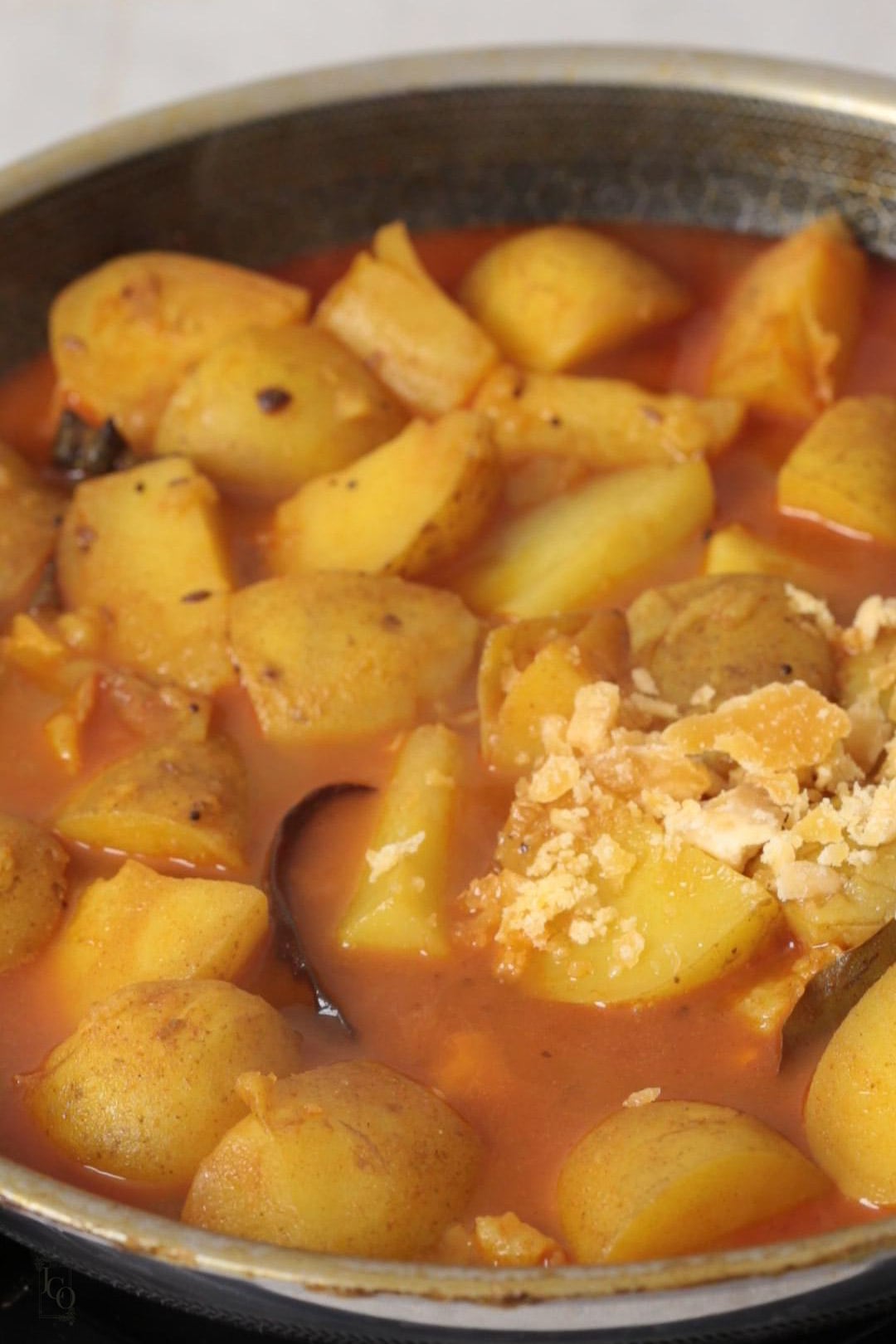crumbled jaggery and imli water added to potato curry.