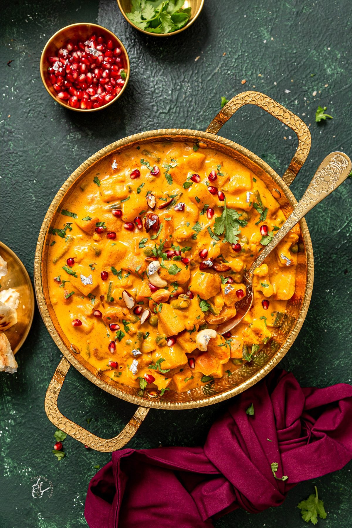 Navratan kurma or vegetable korma served with a serving spoon.