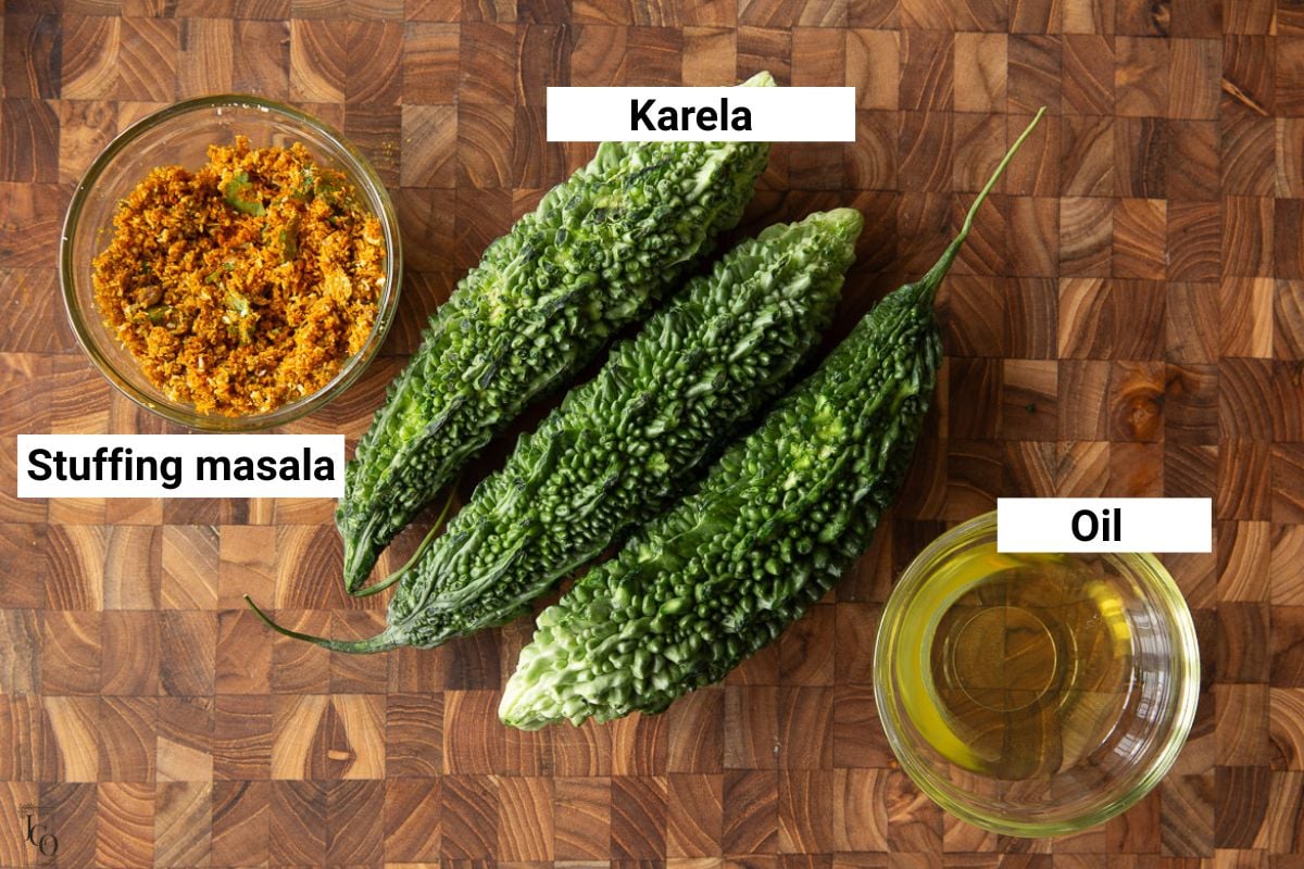 Bitter gourd, oil and stuffing masala in bowls.