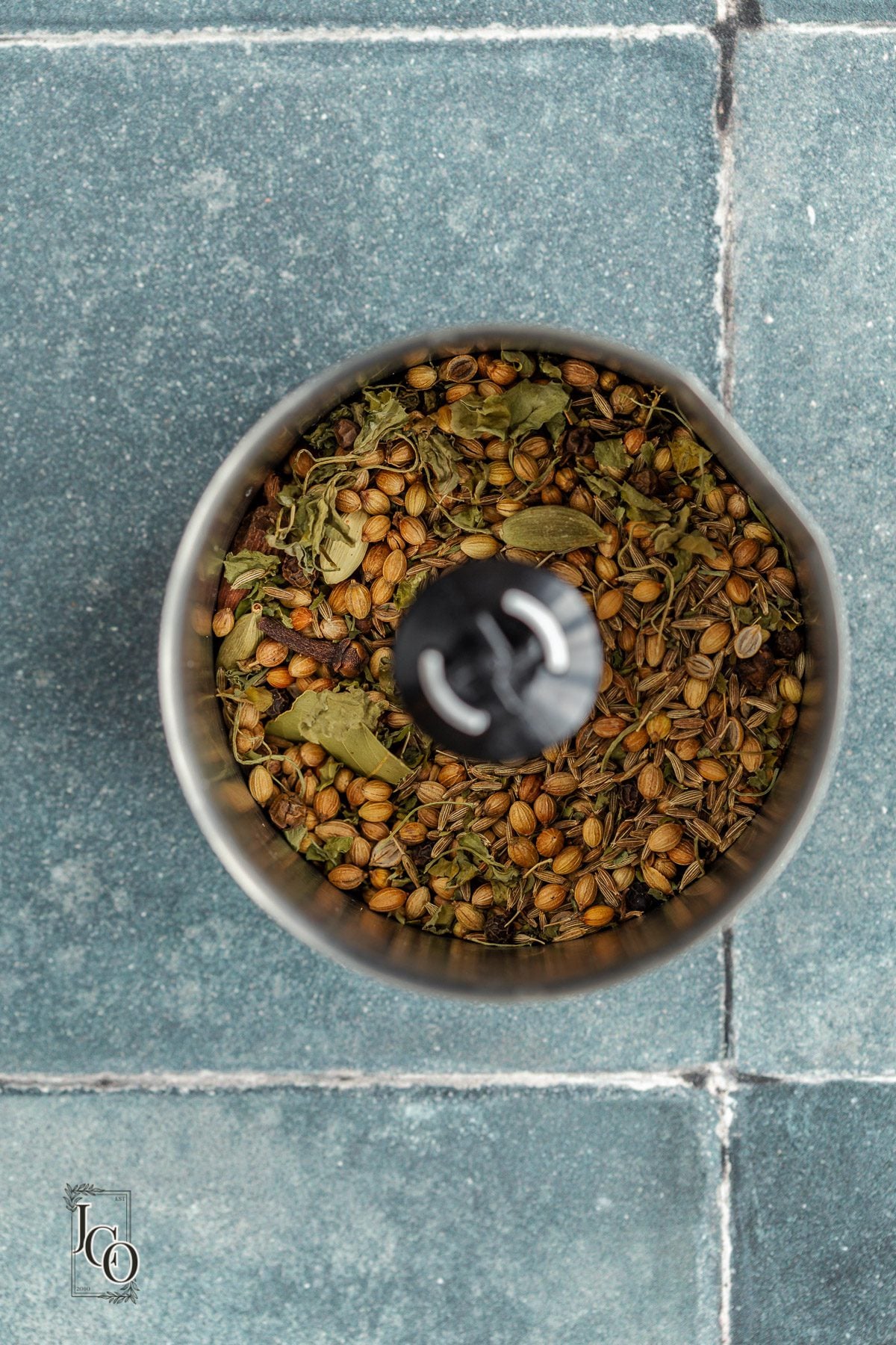 Toasted whole spices in a spice grinder.