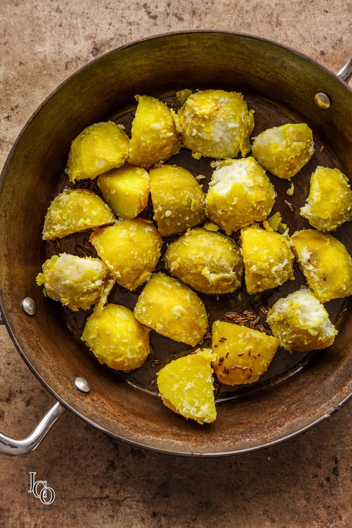 Cut Boiled potatoes in hot oil with cumin seeds in a skillet.
