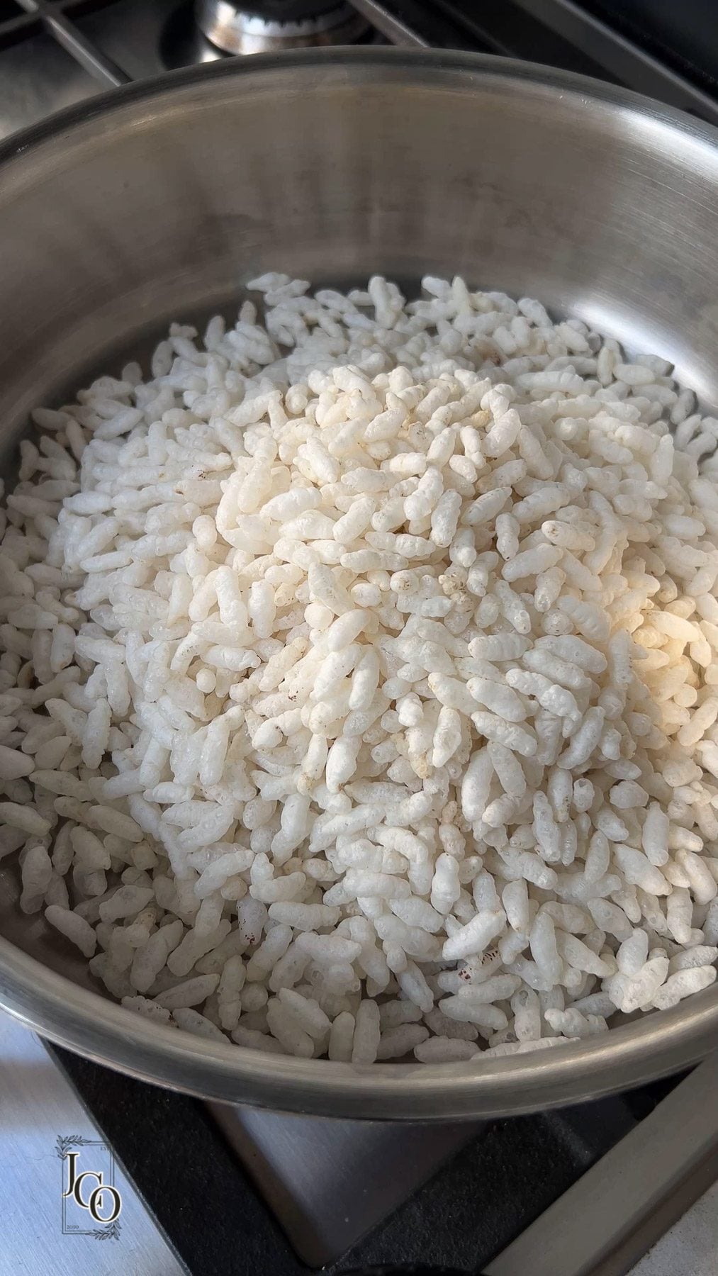Puffed rice in a pan to dry roast on the stovetop.