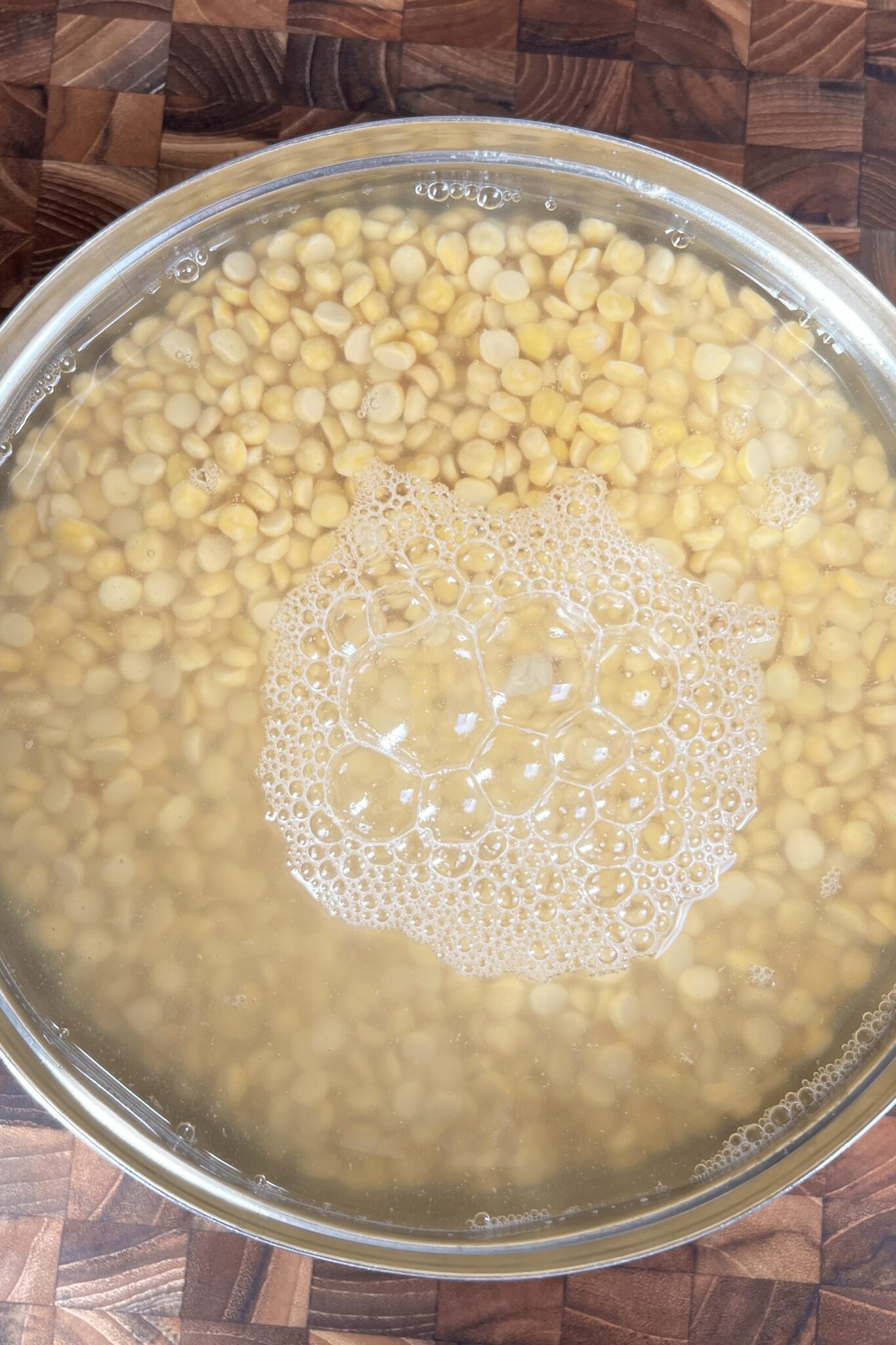 chana dal soaking in clean water in a bowl.