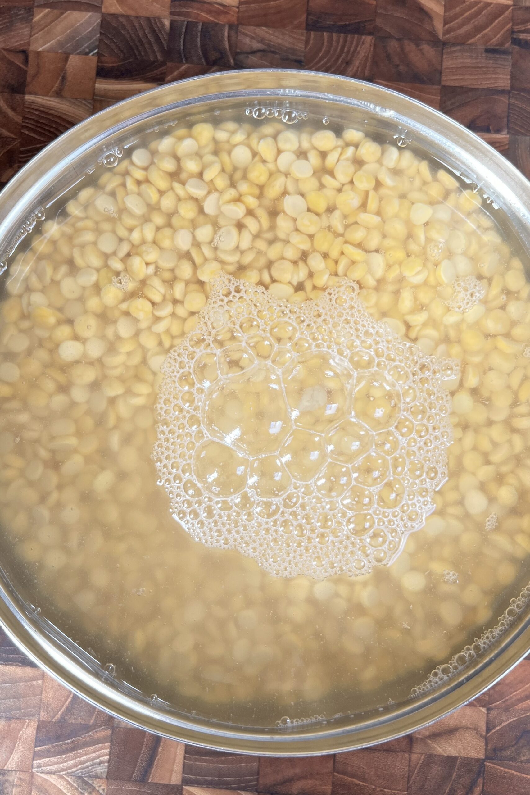 chana dal soaking in clean water in a bowl.