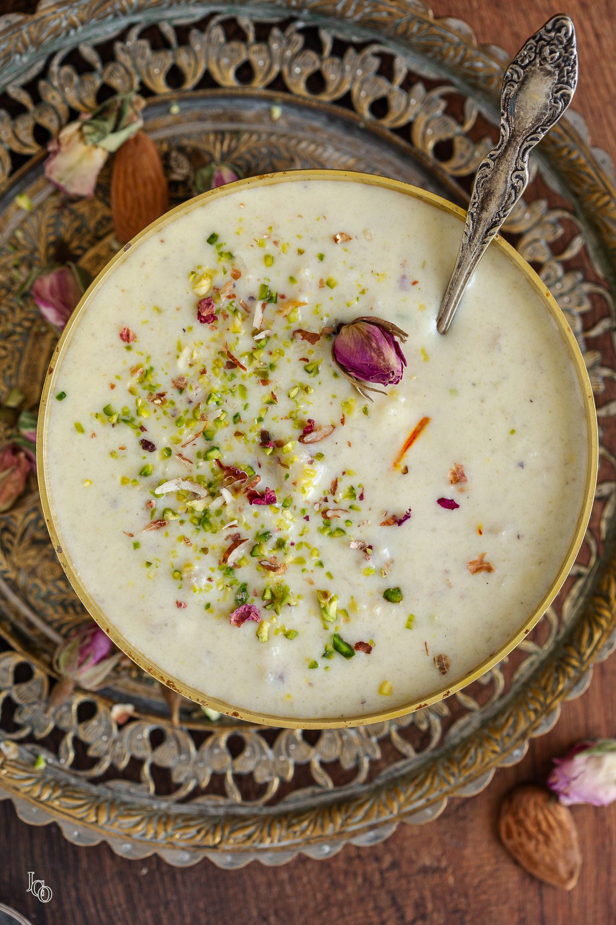 A bowl of makhana kheer placed on a metal serving tray. 