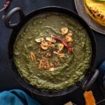 Sarso ka saag served with makki ki roti, jaggery and butter on the side.