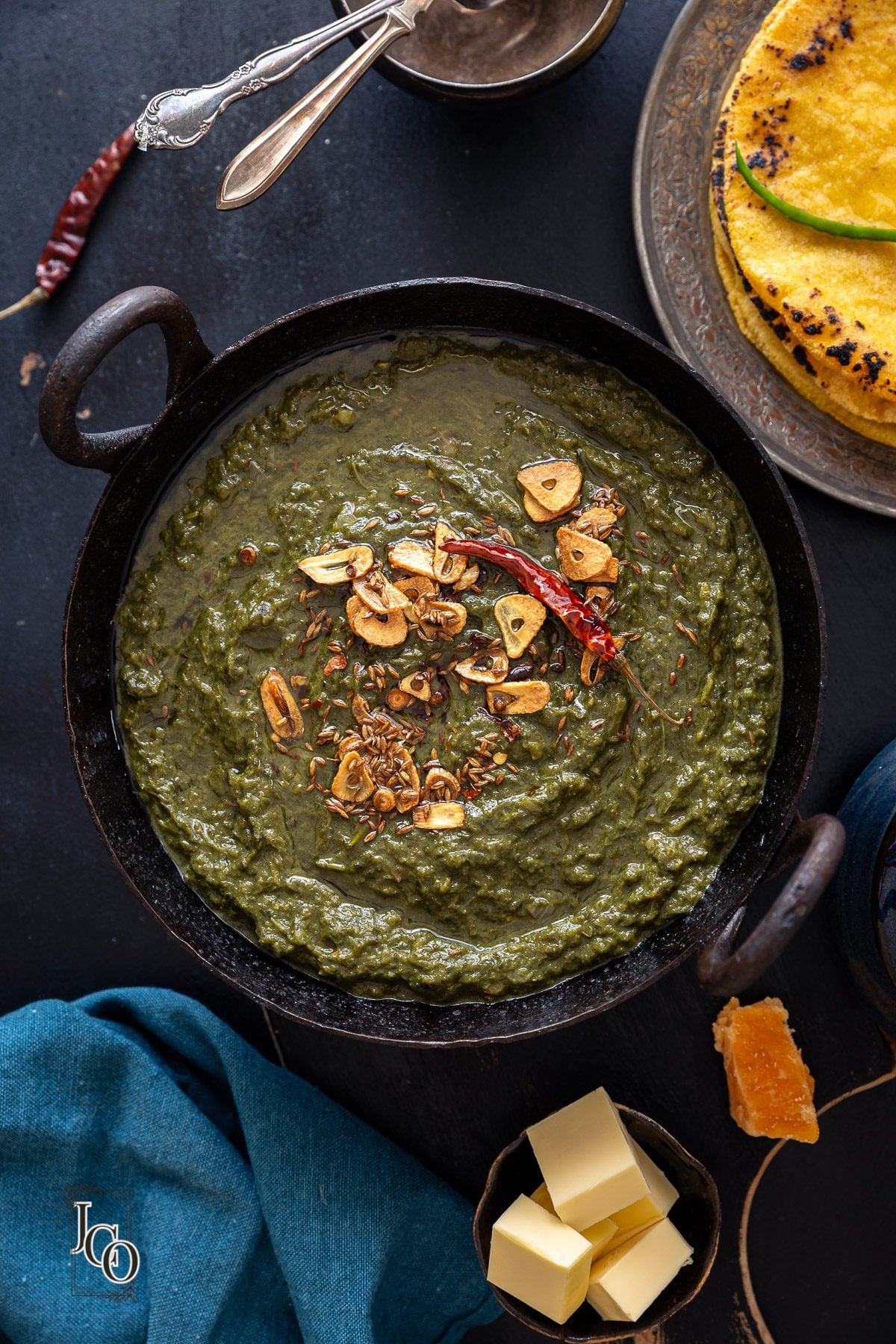 Sarso ka saag served with makki ki roti, jaggery and butter on the side.