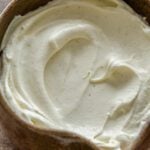 A close up of sweet cardamom whipped cream in a bowl.