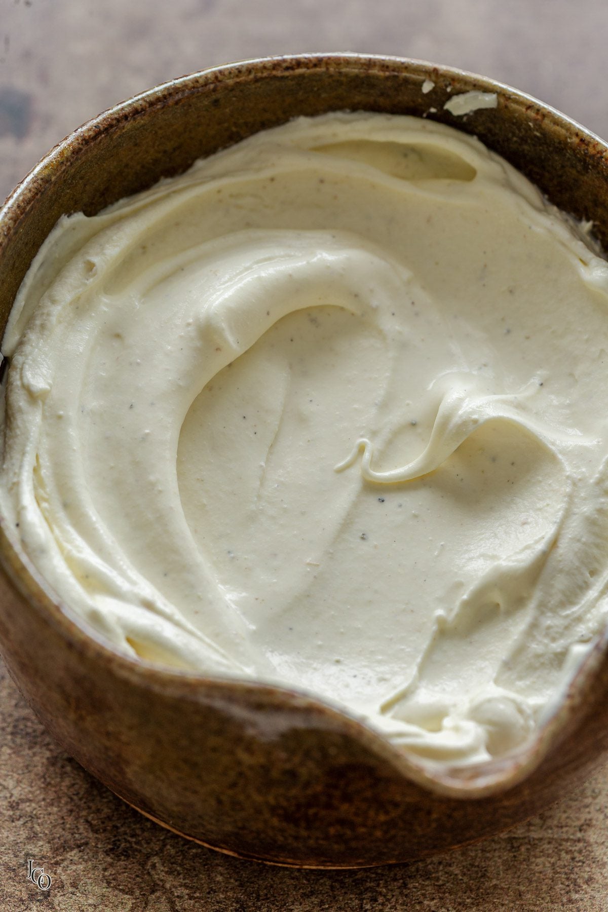 A close up of sweet cardamom whipped cream in a bowl. 