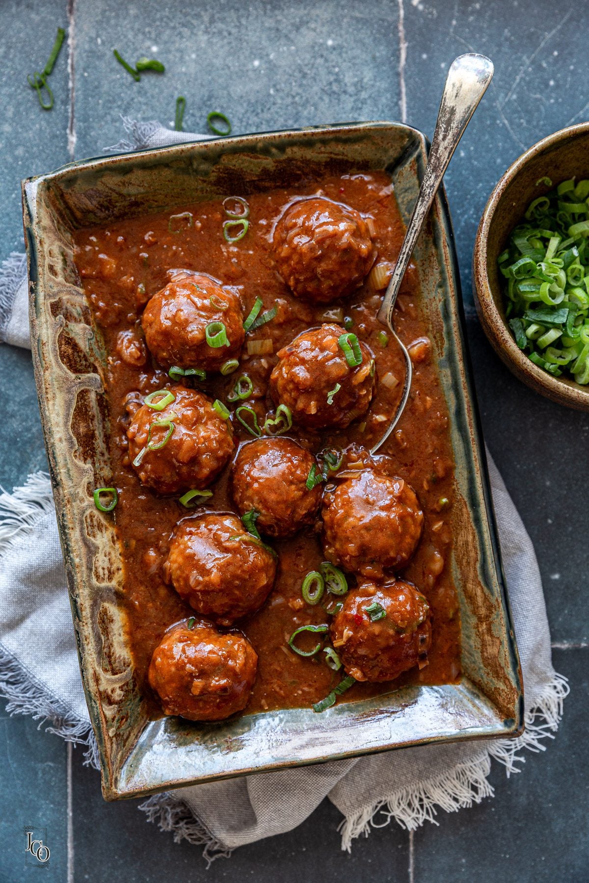 Veg manchurian served in a serving tray with a serving spoon.