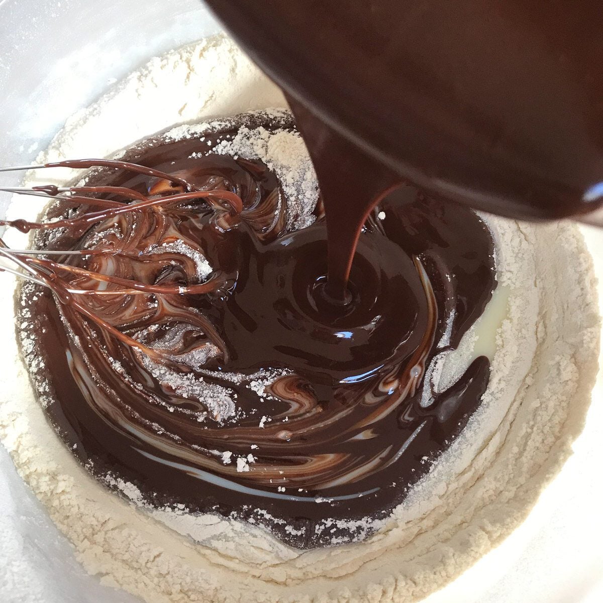 Melted butter and chocolate mixture added to the dry ingredients to make brownies.