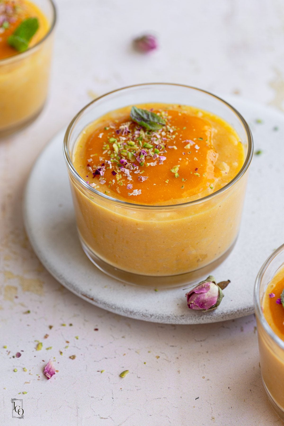 Coconut mango doodh poha served in three clear glass bowls.