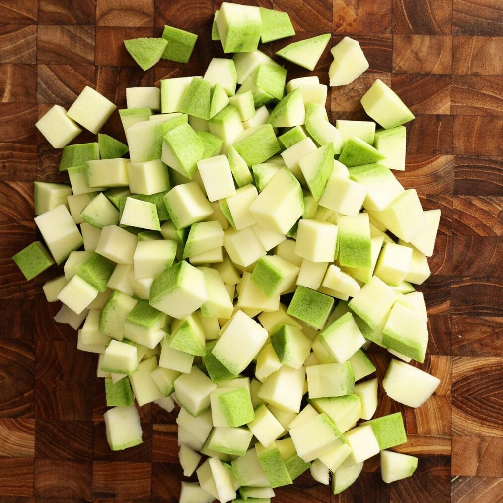 Cubes of raw mango pieces on the chopping board.