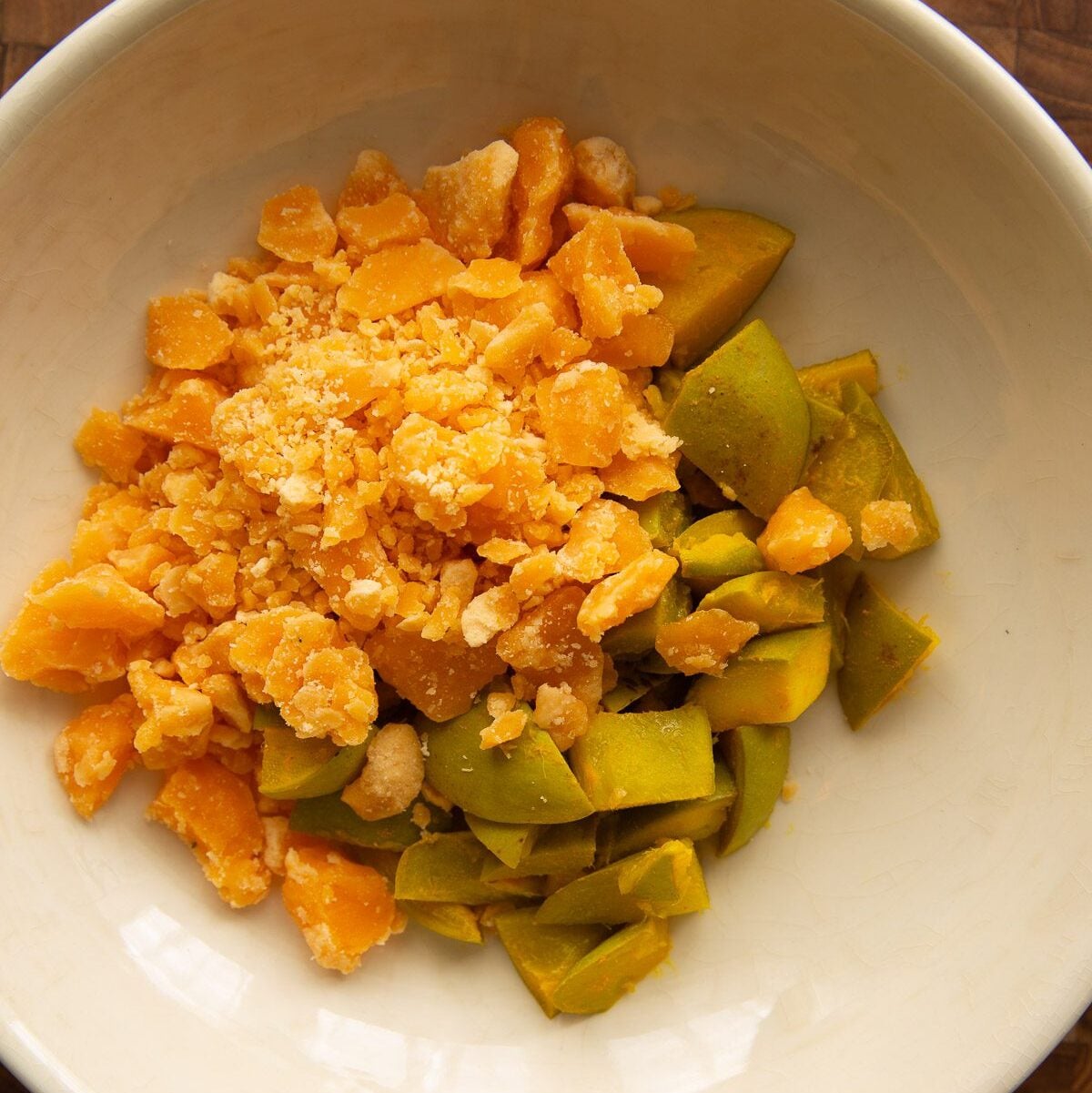 Grated jaggery added to the steamed mango pieces.