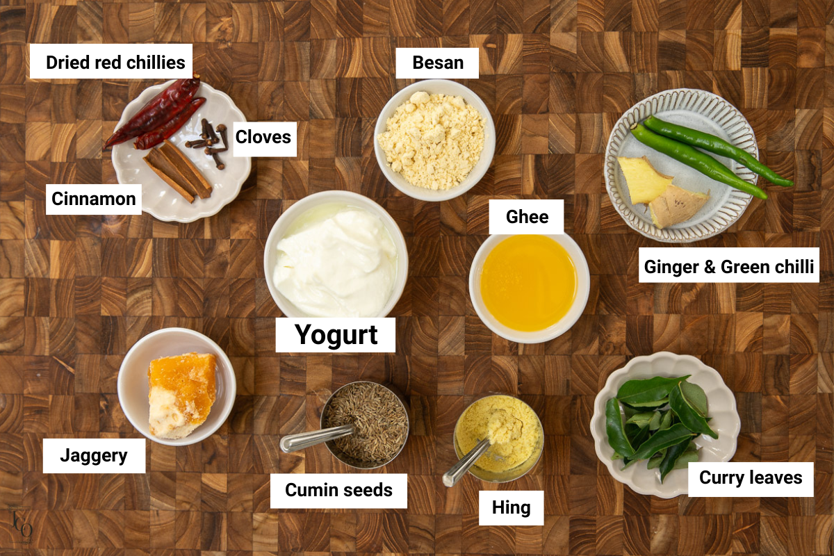 Gujarati kadhi ingredients - Plain yogurt, besan, spices and ghee in white bowls. 