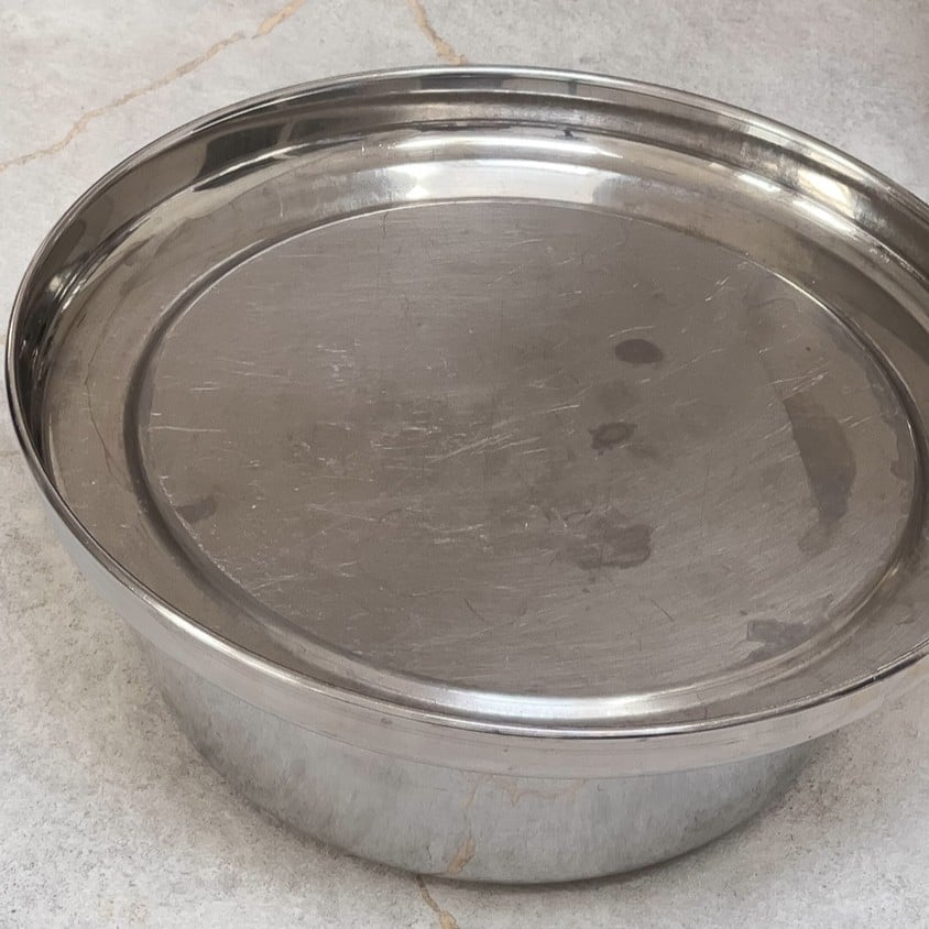 Steel bowl covered with steel plate. 