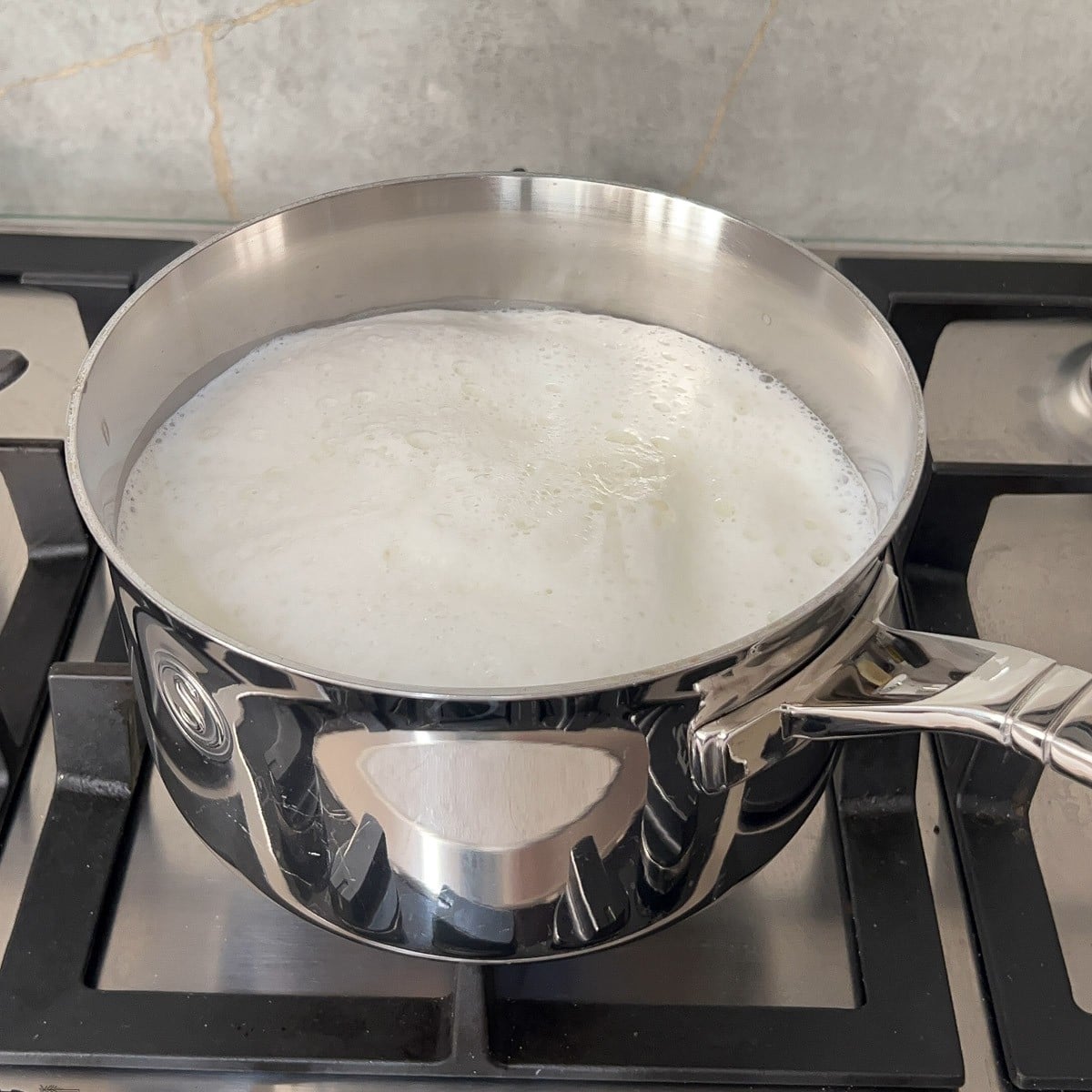 Milk simmering in a saucepan. 