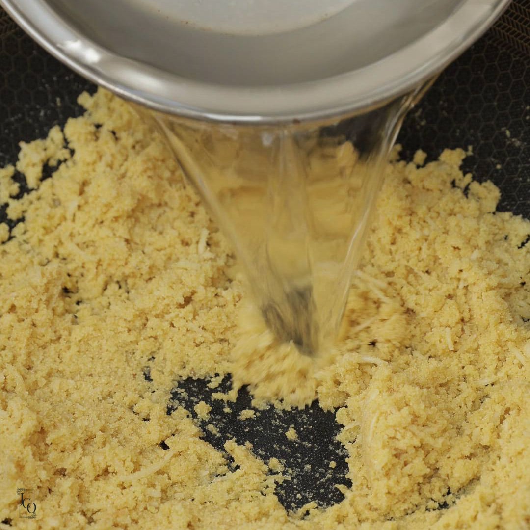 Water poured over semolina in a pan.