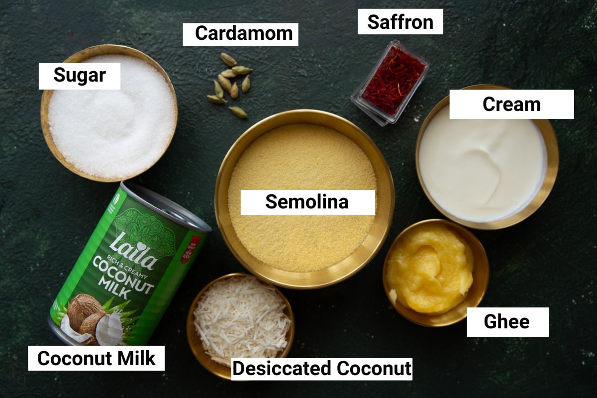 Semolina, coconut milk, sugar, ghee, saffron, cardamom pods in bowls.