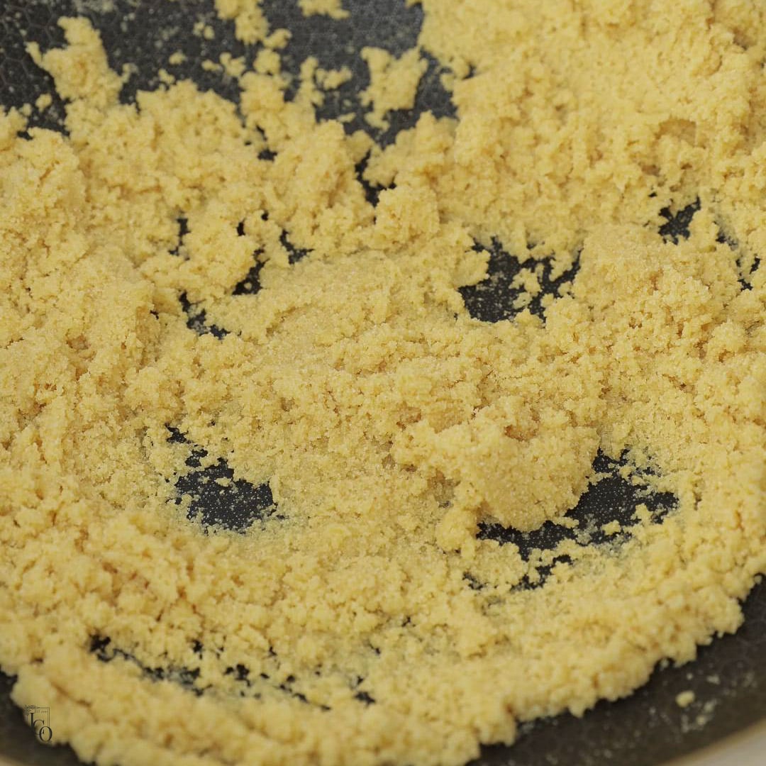Semolina roasting in ghee in a pan.