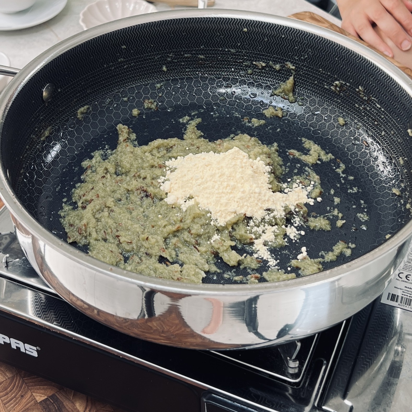 Gram flour added to cooked onion mixture.