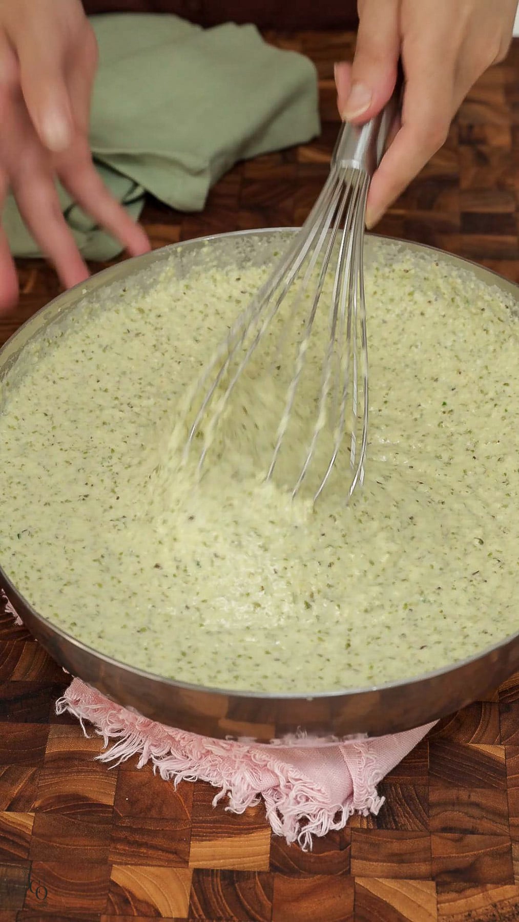 Light and fluffy moong dal batter in a bowl. 